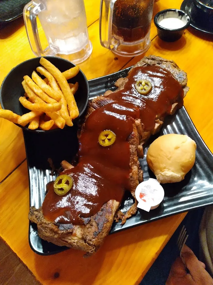 While Slab of Ribs with BBQ Sauce & Jalapeno Slices Fries